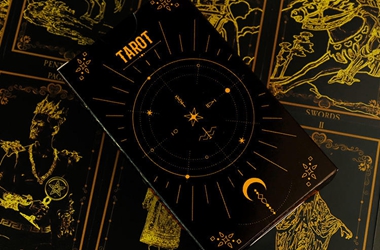 Premium custom tarot cards, oracle cards, and lenormand decks with gold foil edges.